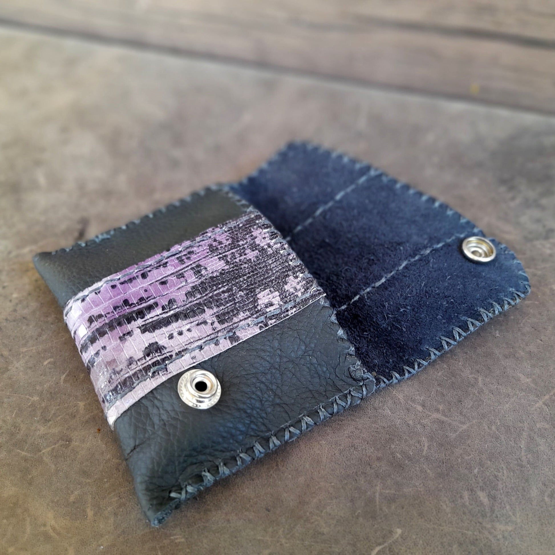 the black leather flap OOAK wallet, laying flat, showcasing its single large compartment