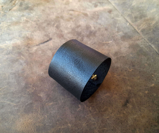 Black leather cuff on a textured surface