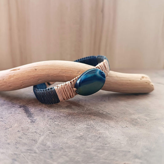 a leather bracelet with a blue agate stone close up side view
