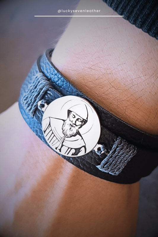 Black pebbled Leather bracelet with a circular emblem featuring St. Charbel on a person's wrist.