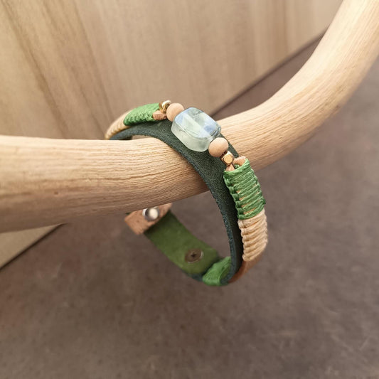Close up Side view showing the prehnite, snadalwood beads and braided macramé cord and olive leather