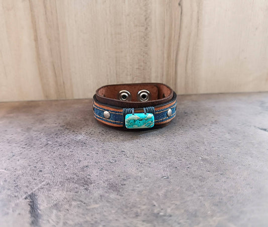 Front view of the Denim and Crazy Horse leather cuff, showcasing the rectangular Imperial Jasper stone and the braided industrial gray cord attachment.