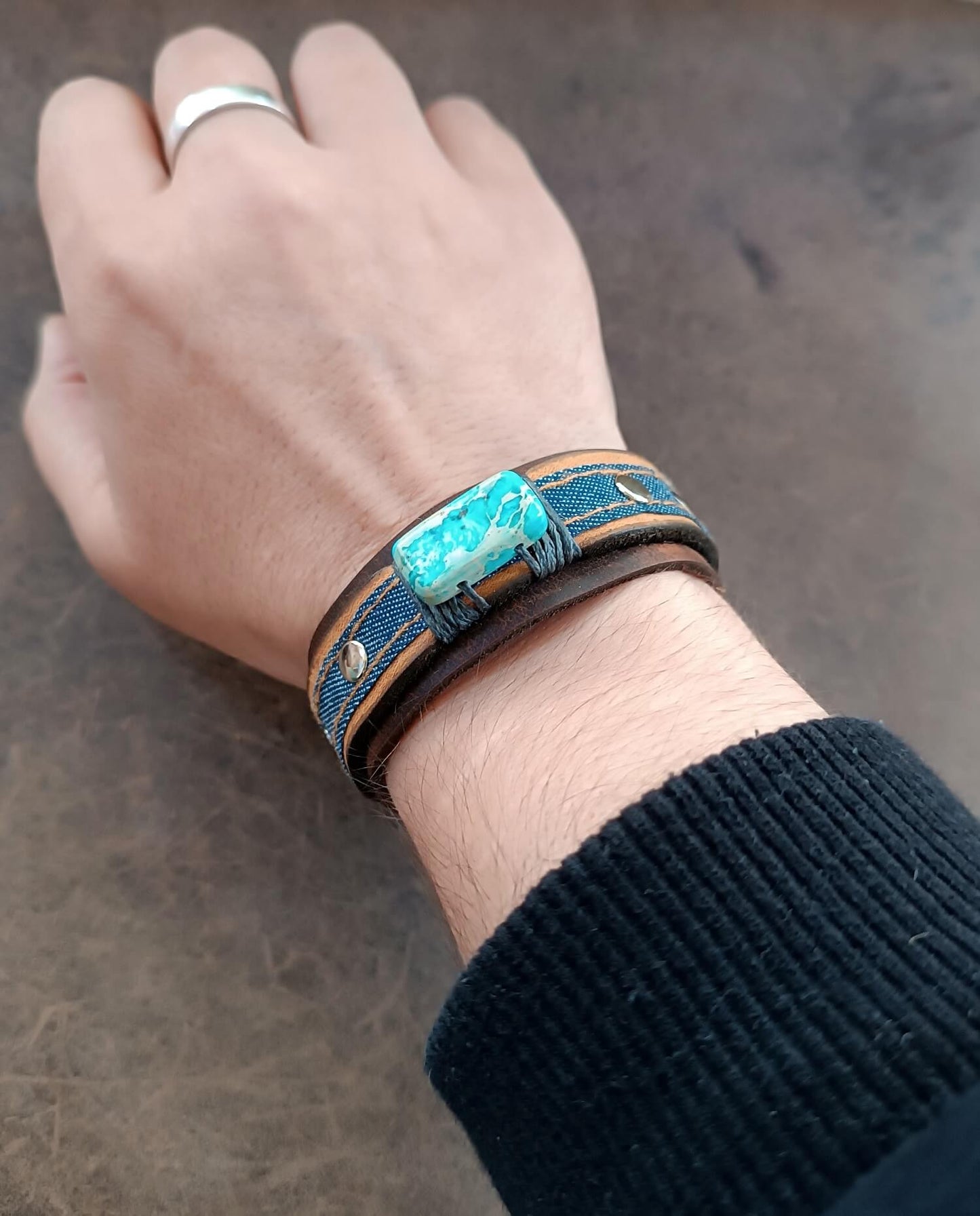 Blue Imperial Jasper and Denim leather cuff worn on wrist, highlighting the Boho-Gypsy aesthetic and loose fit on a wrist.