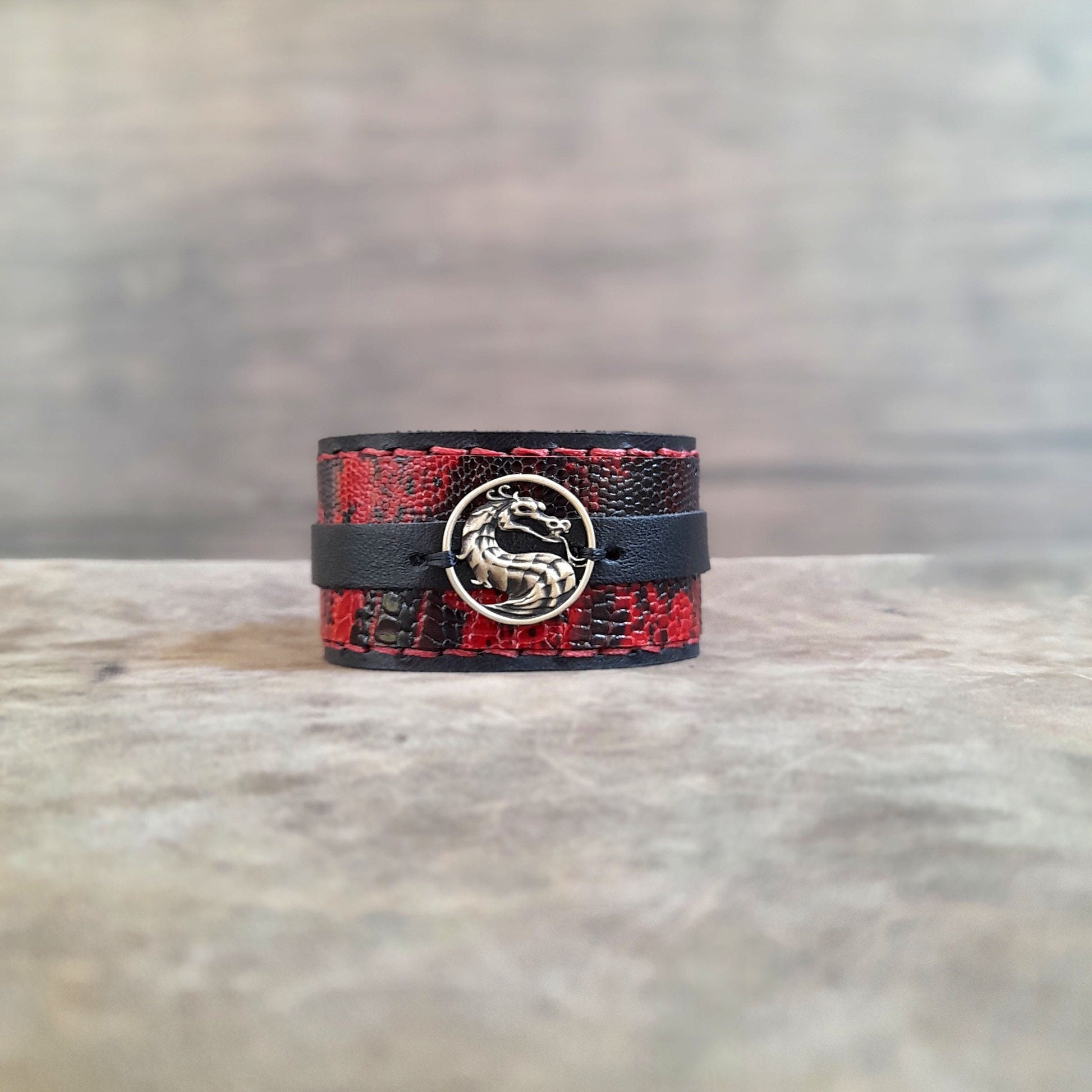 Front View of the layered dragon cuff showing the tarnish-free brass pendant and snake print texture.