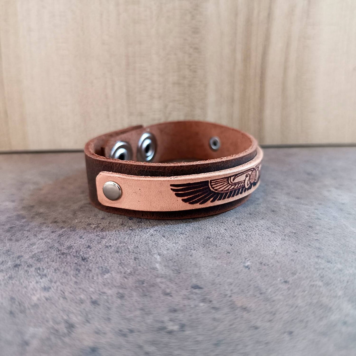 Brown leather bracelet with egyptian winged disc desgin side view