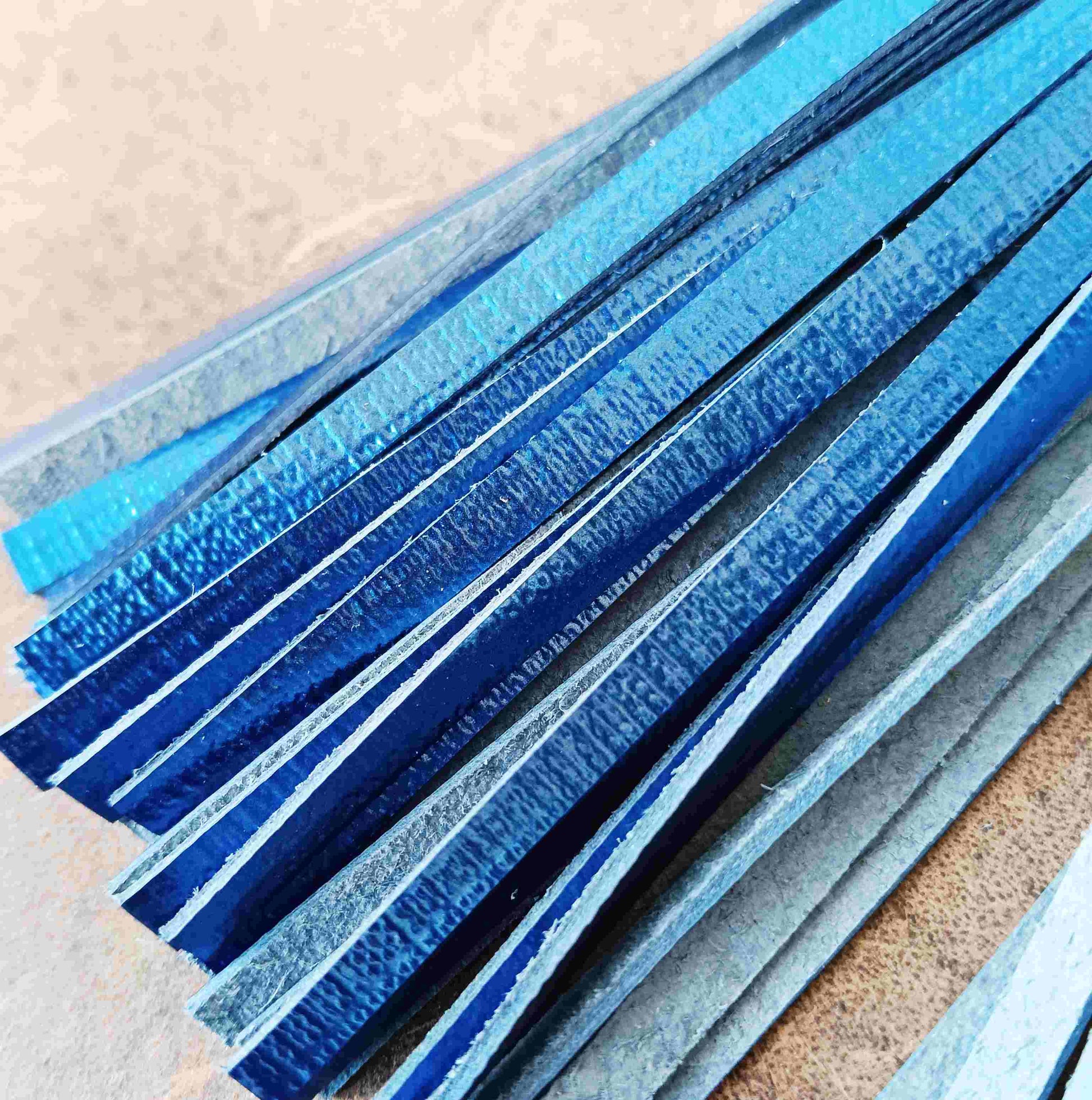 close up shot of the electric metallic blue leather tassel