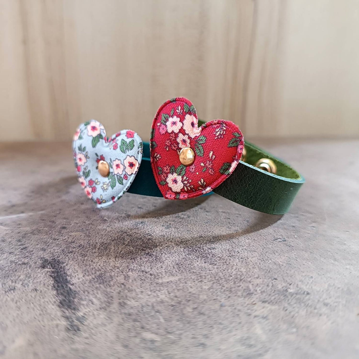 Two handmade leather bracelets for girls, one green with red floral fabric heart and one petrol blue with light blue floral heart