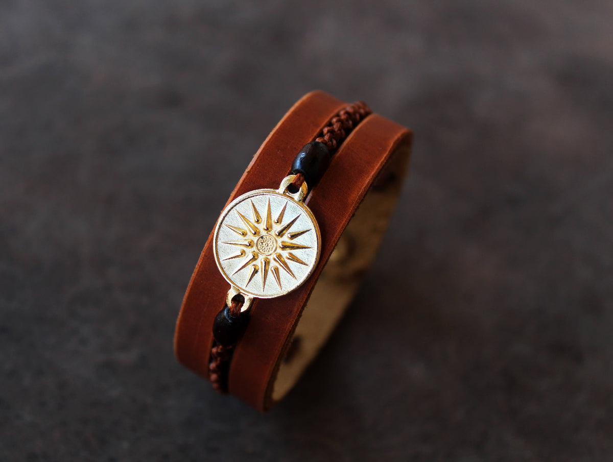 handmade brown leather cuff bracelet featuring a vergina sun pendant