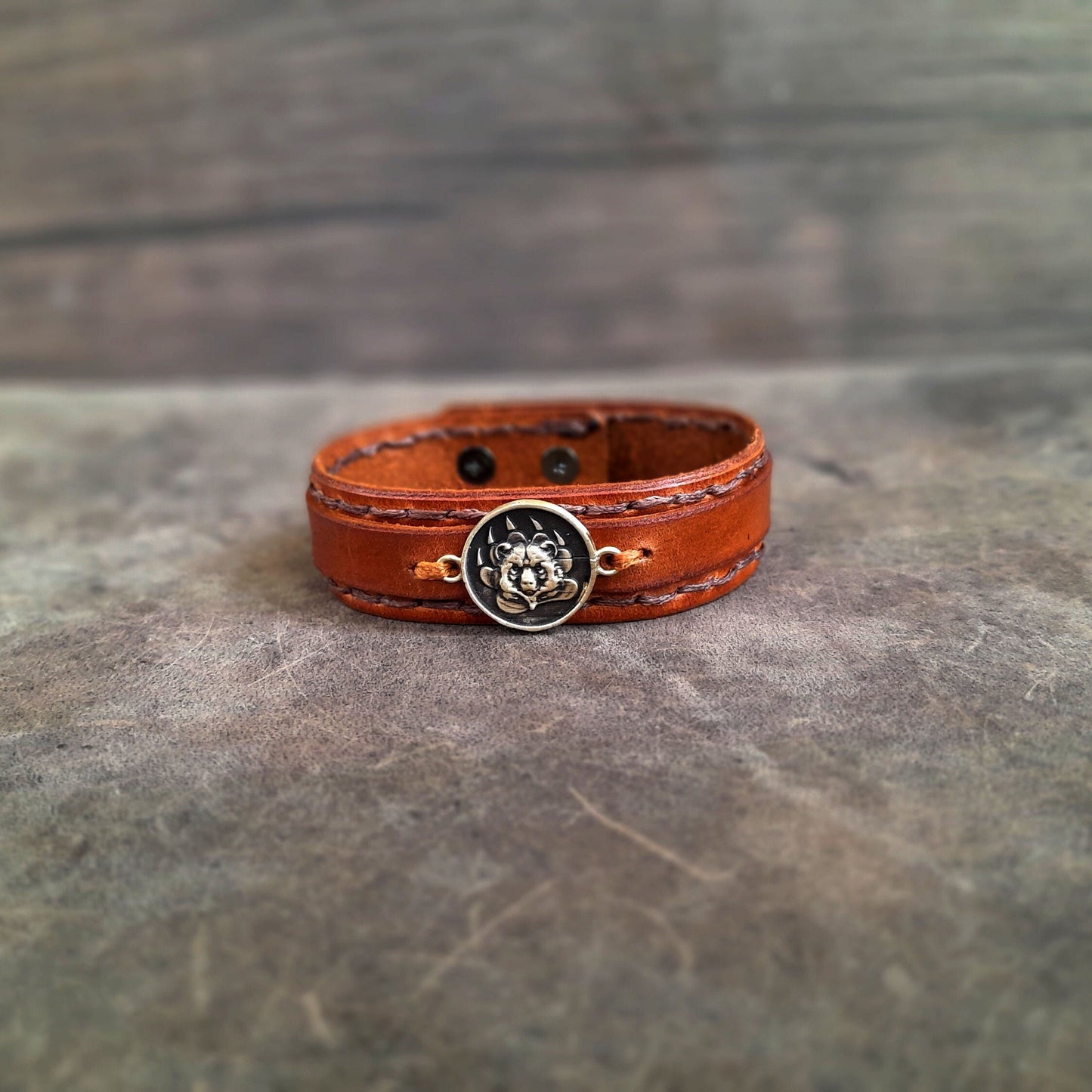 Minimalist Grizzly Bear leather bracelet in brown Crazy Horse leather with brass bear charm.