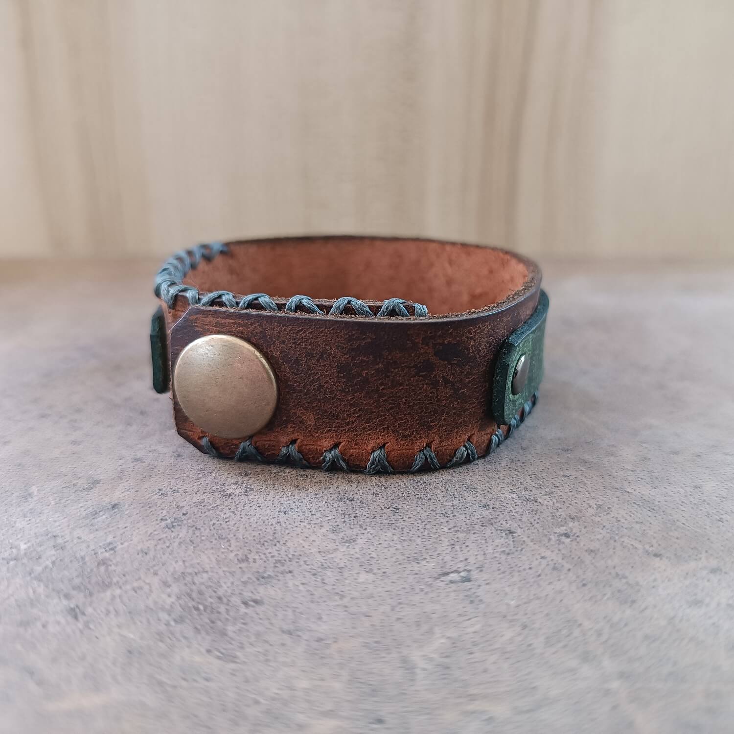 Growling Wolf Bracelet in weathered Brown and khaki backside view showcasing snap closure
