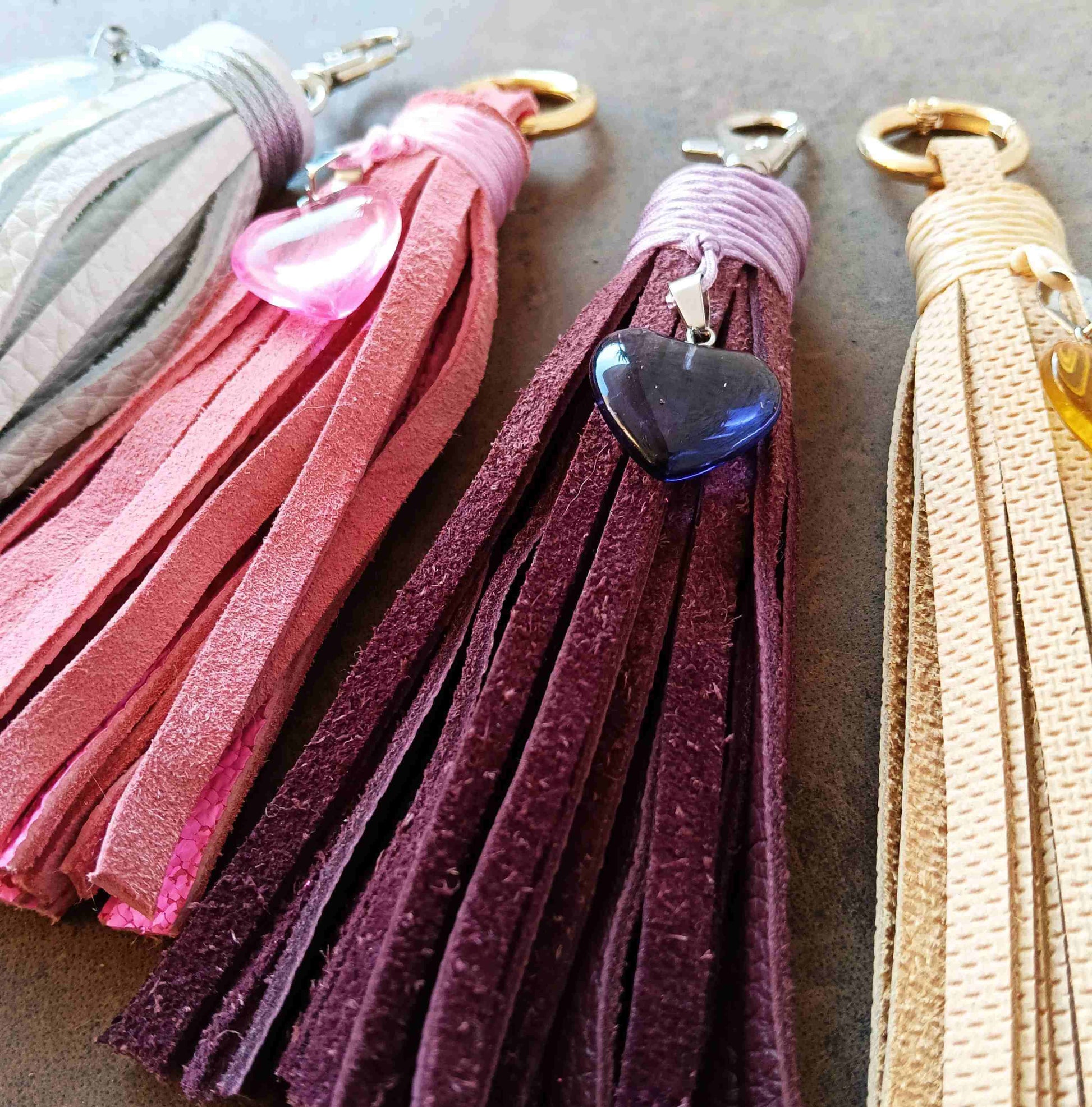 four leather tassel bag charms featuring hearrt pendants