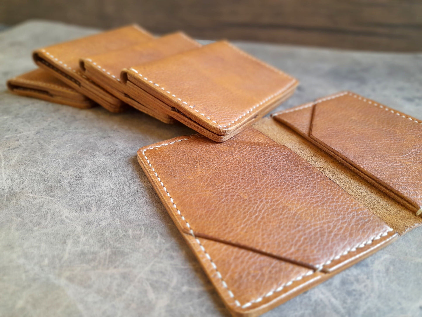 close up of the Minimalist handmade leather bi-fold wallet in brown full grain leather, showcasing the interior.