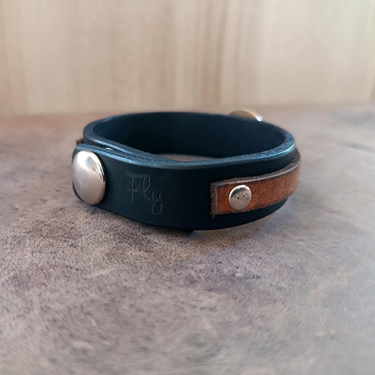 Leather bracelet with Karasuno Crow Pendant backside view with "Fly" engraving