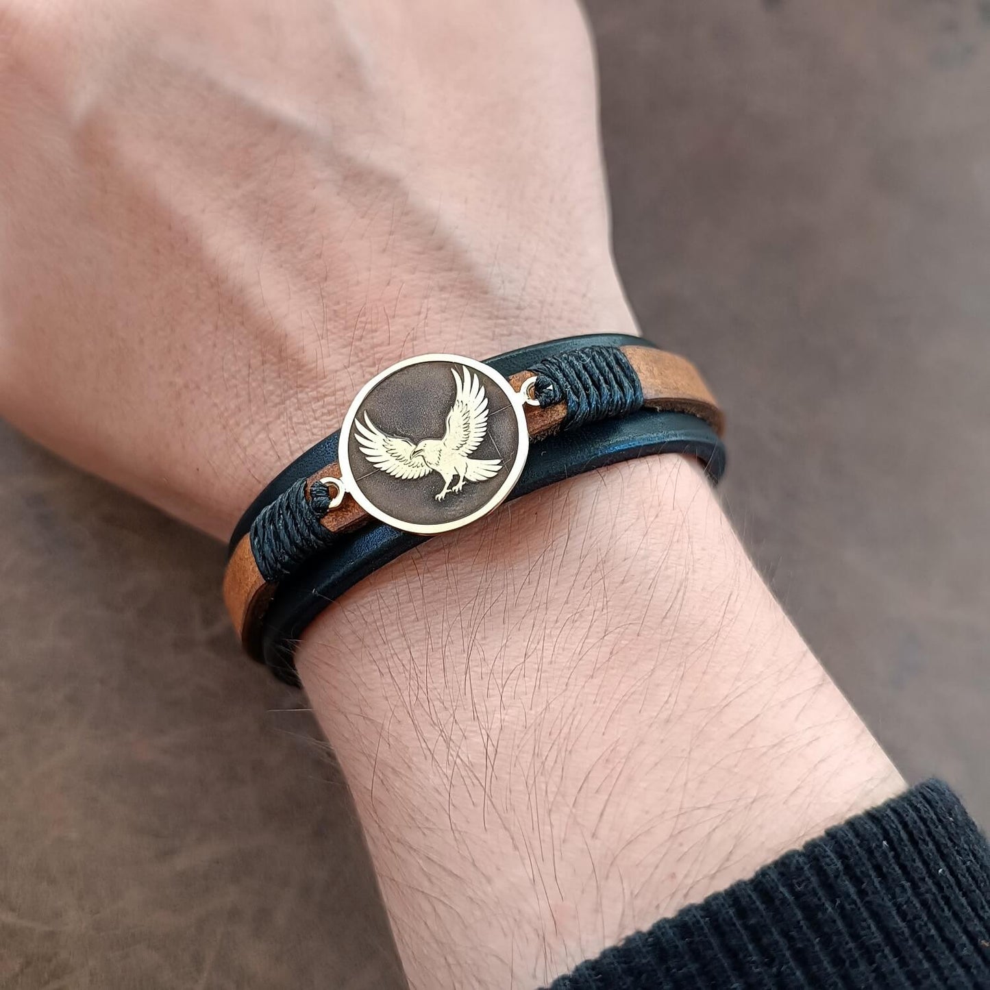 Leather bracelet with Karasuno Crow Pendant worn on wrist