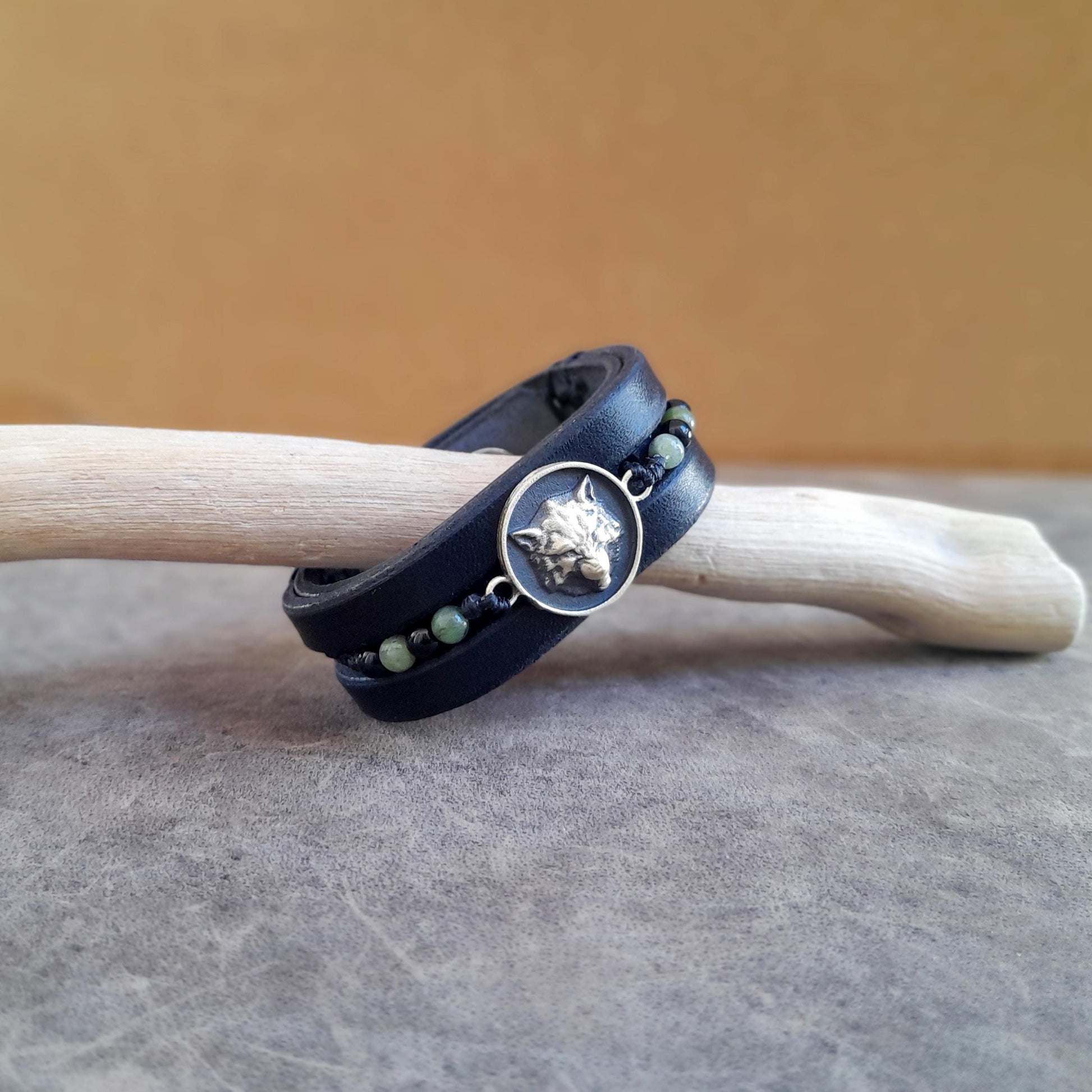 Detailed view showing the three separate layers of black Vachetta leather and beeswax stitching.