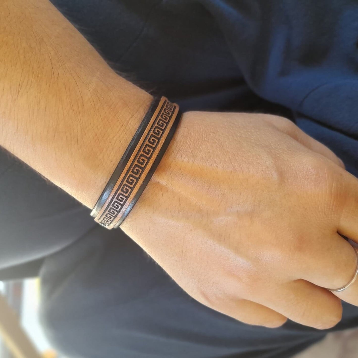 Greek meander leather bracelet worn on wrist — minimalist unisex design