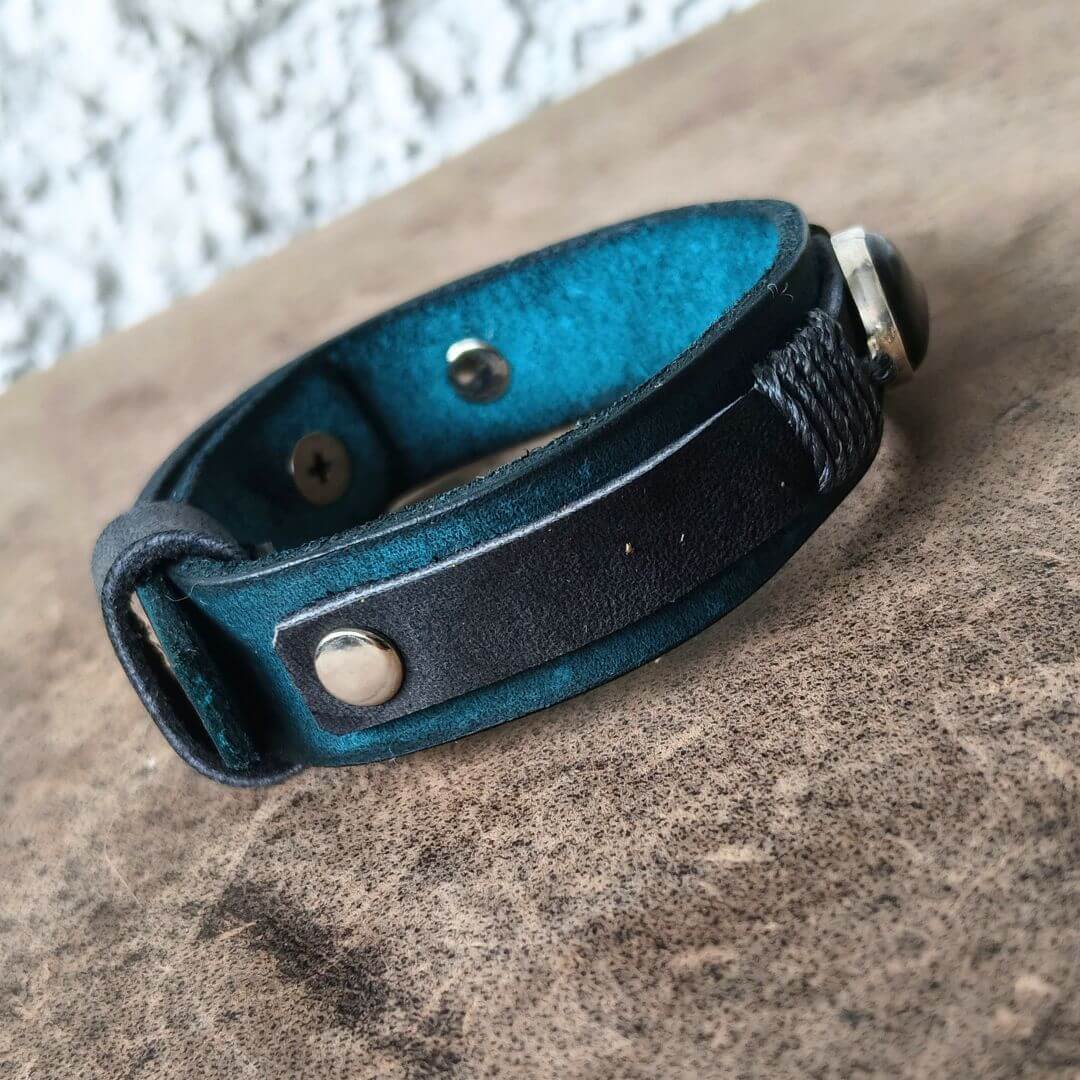 Muted blue and black men's leather bracelet with matte black onyx side view