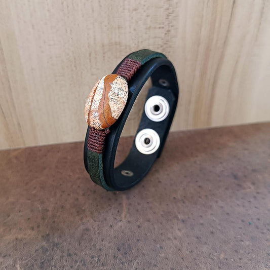 Black and green layered leather bracelet featuring a large oval natural picture jasper stone, close up sideway view showcasing leather thickness and smooth edges