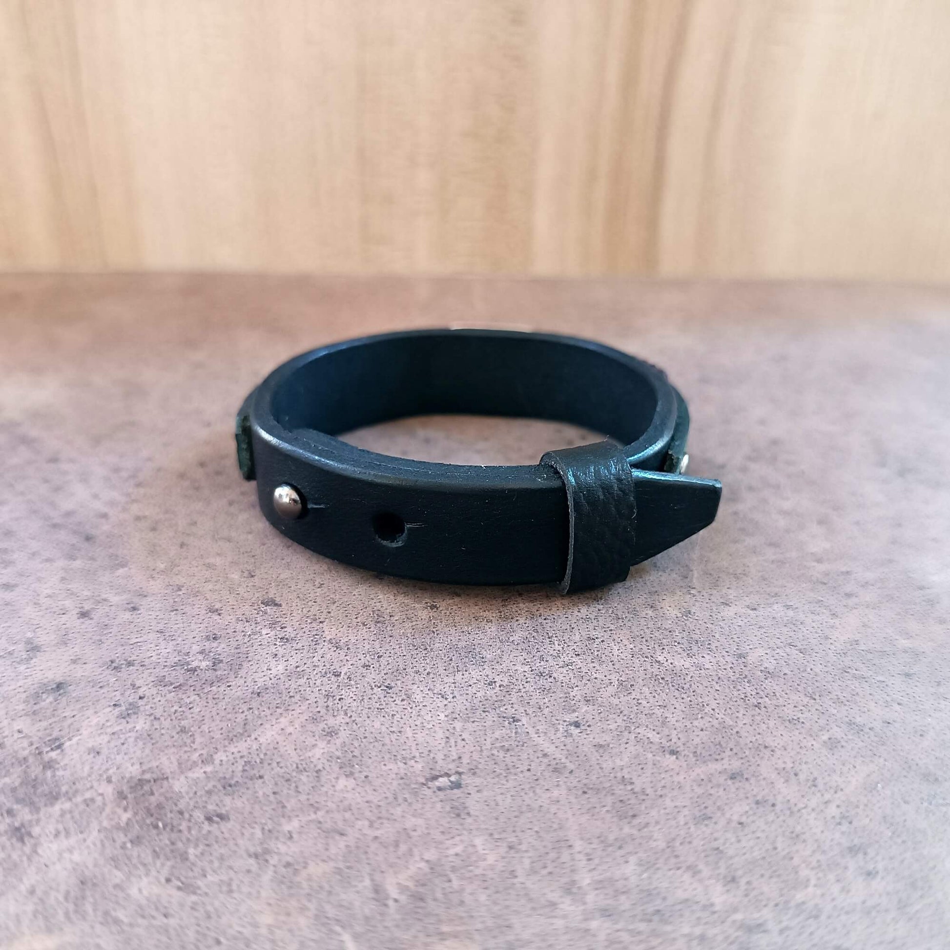 backside view of the black vachetta band, showing closure and openings for adjusting