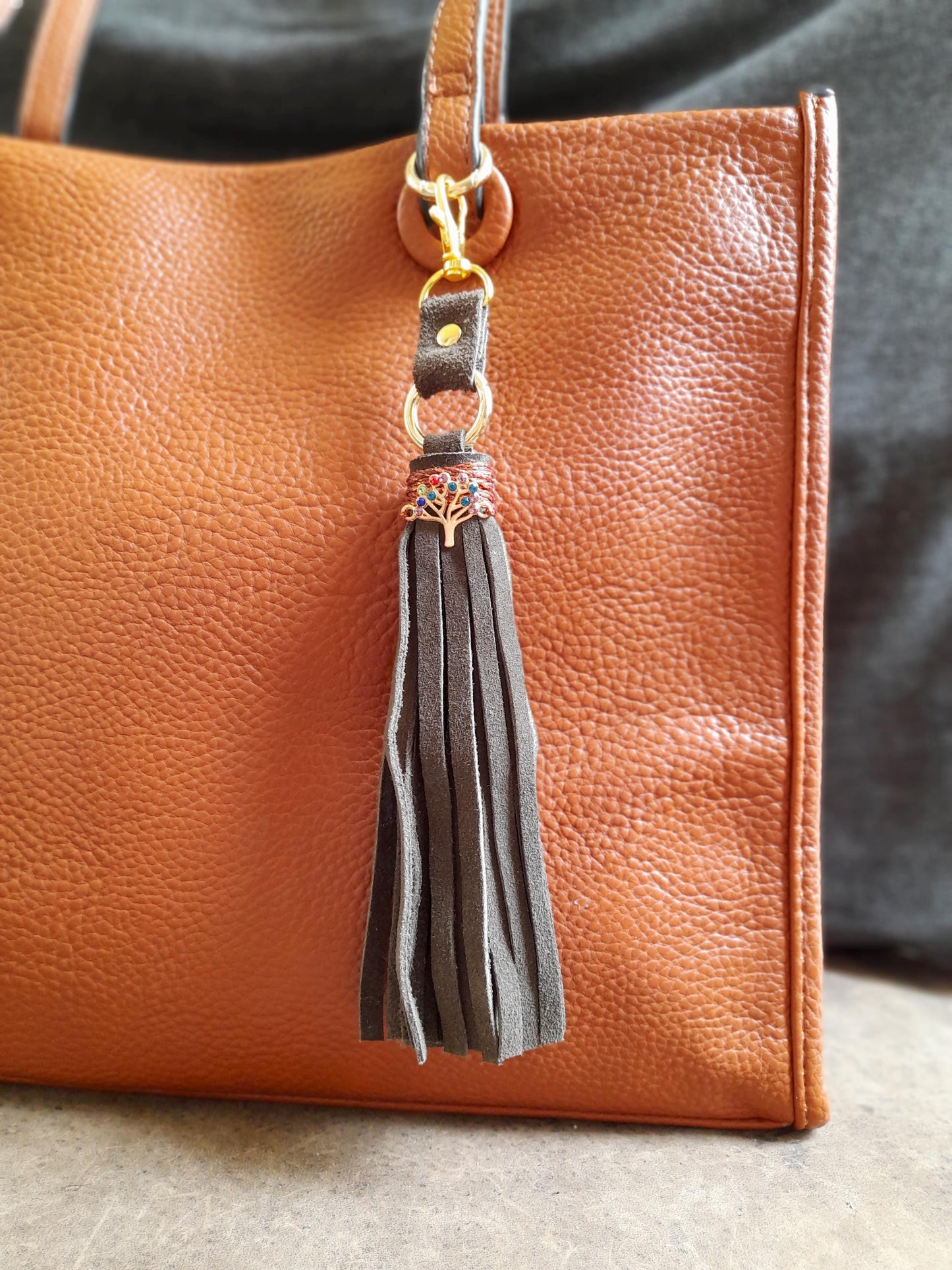 Tree of Life bag charm with olive green suede tassel and colorful rhinestone pendant.
