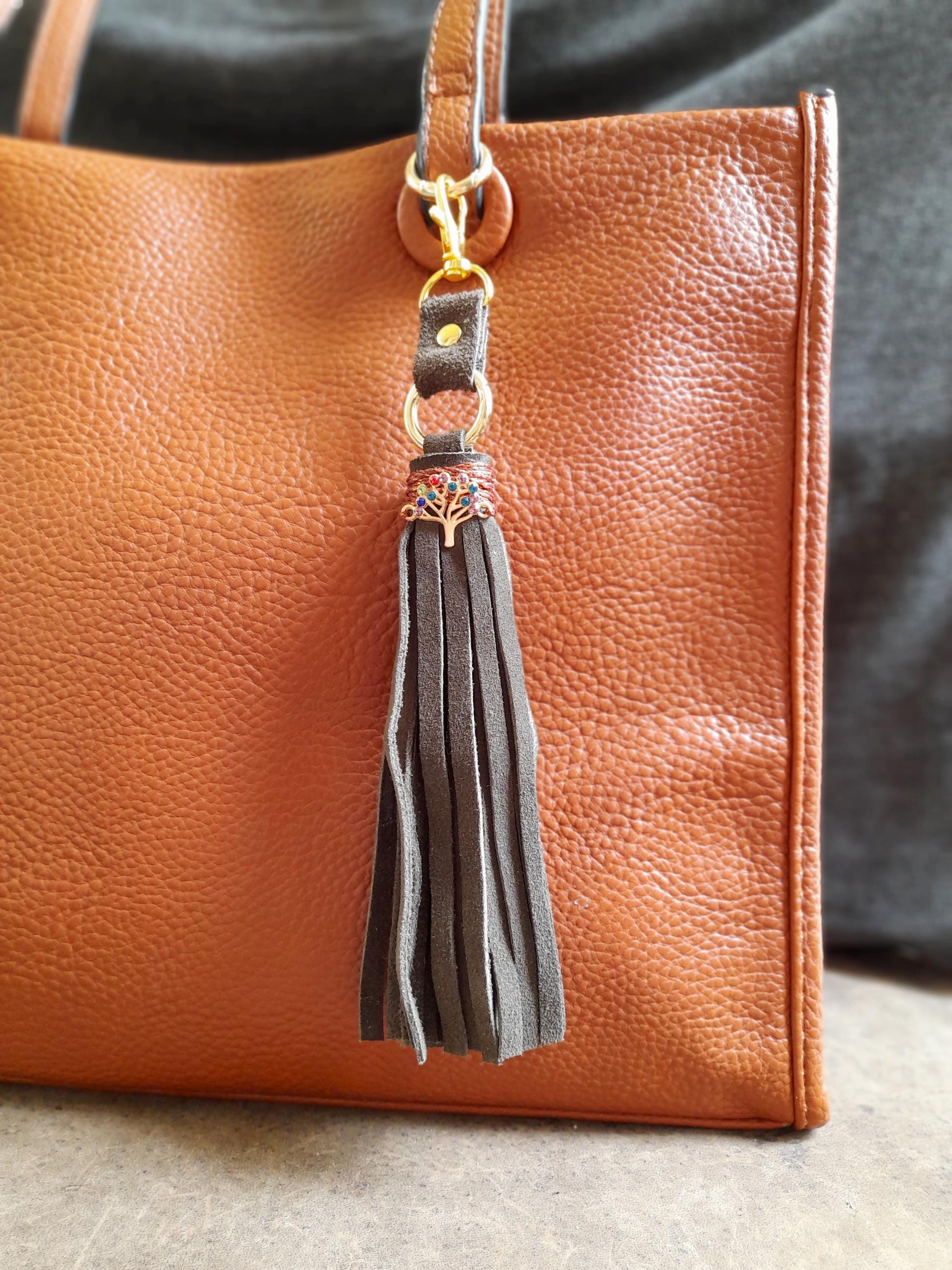 Tree of Life bag charm with olive green suede tassel and colorful rhinestone pendant.